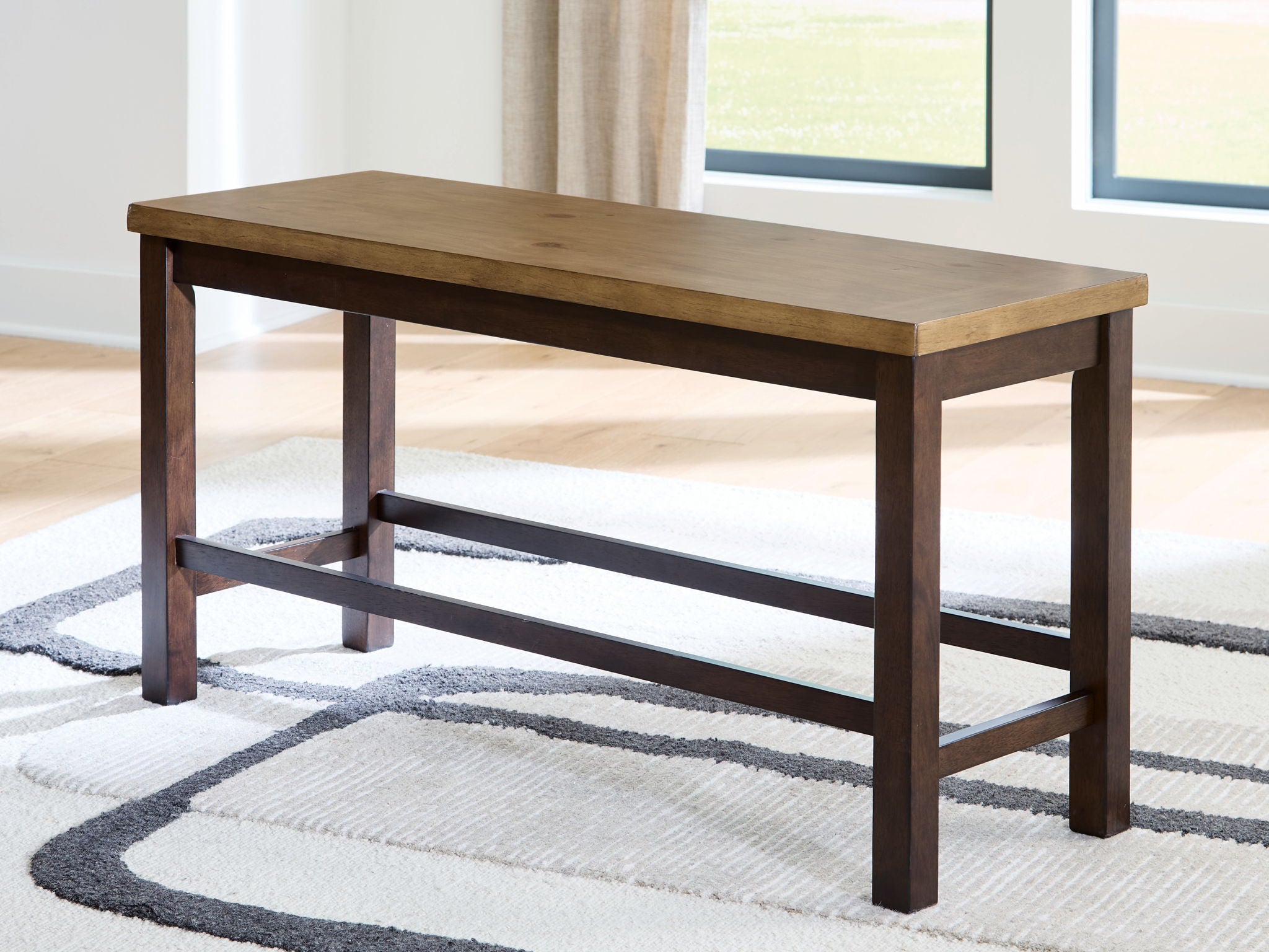 Double counter height bench with light and dark brown wood frame and lower crossbar