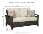 Woven loveseat with cushion, dark brown frame, light beige seats, two leaf-print pillows