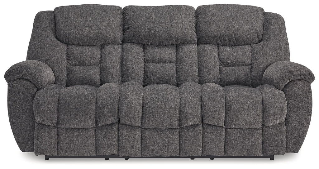 Charcoal gray reclining sofa with three seat cushions and rounded padded arms