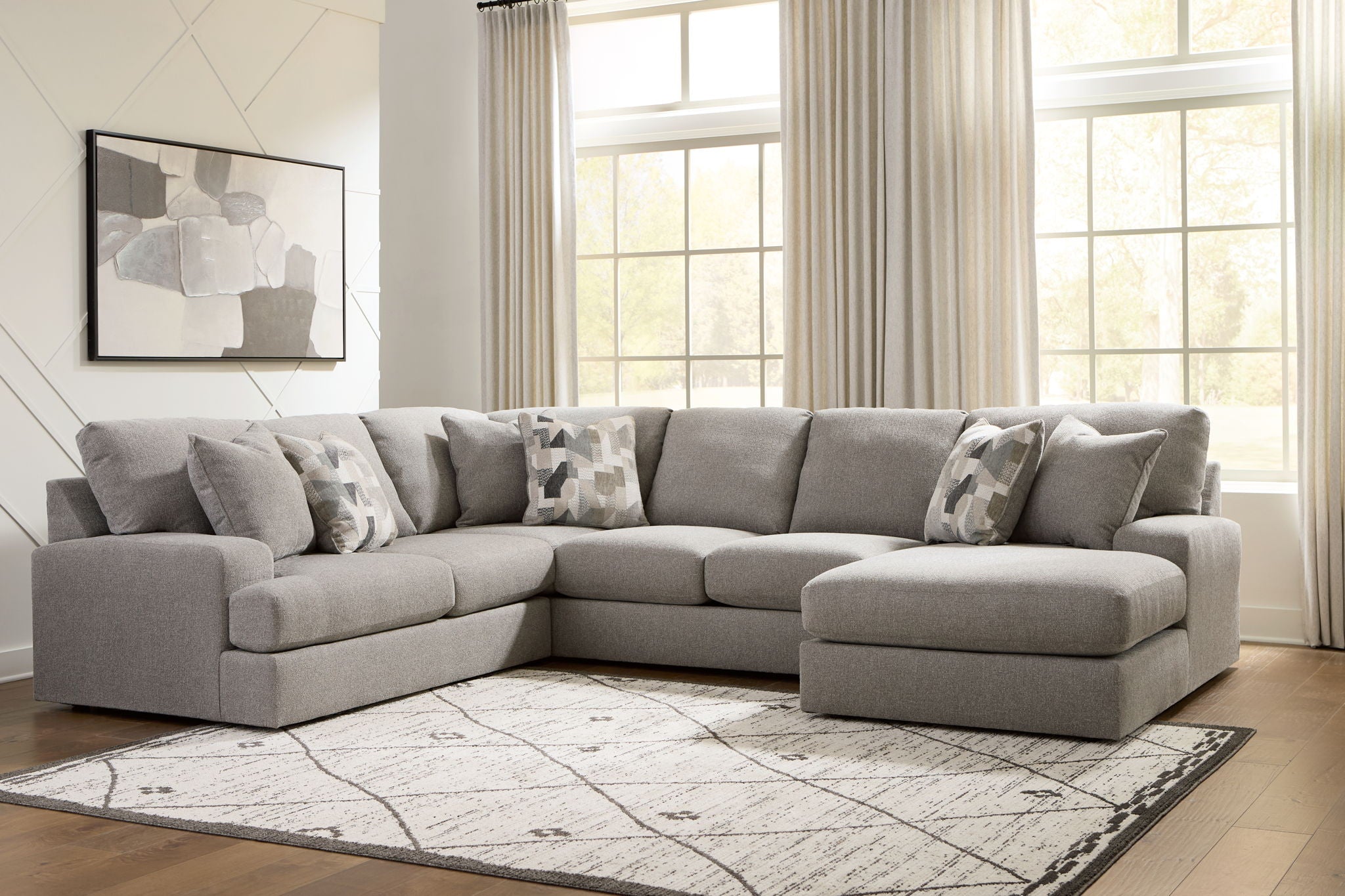 Lindon sectional sofa in smoke gray with corner chaise and patterned accent pillows