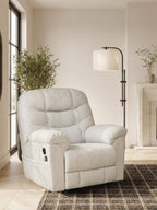 Light beige recliner with overstuffed arms, tufted back, and visible recline mechanism