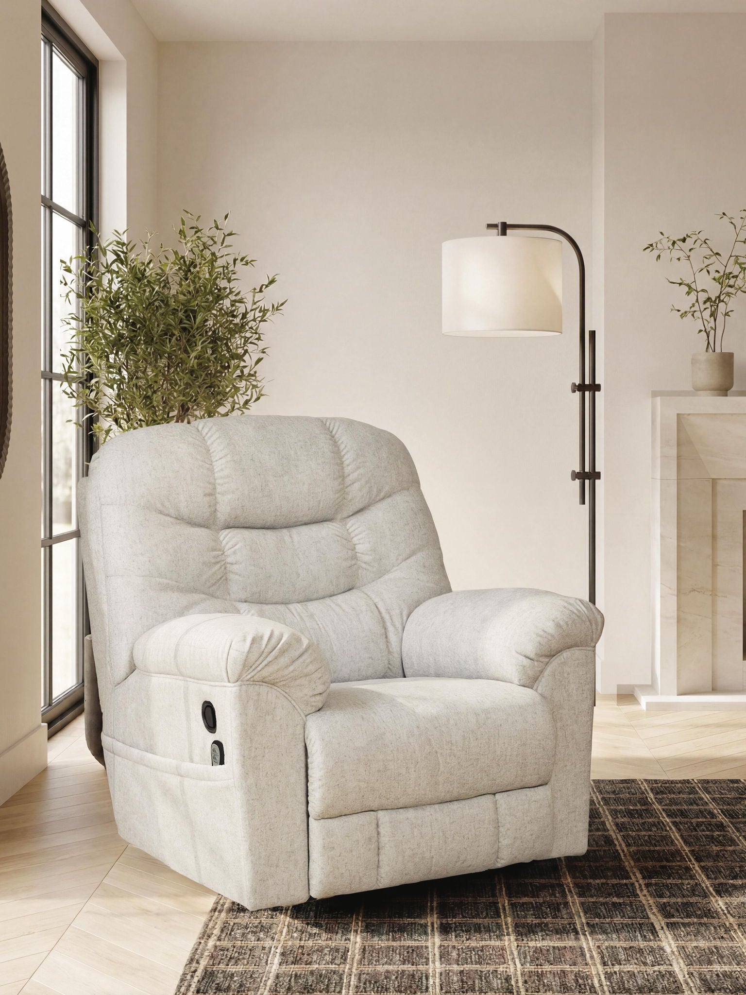 Light beige recliner with overstuffed arms, tufted back, and visible recline mechanism