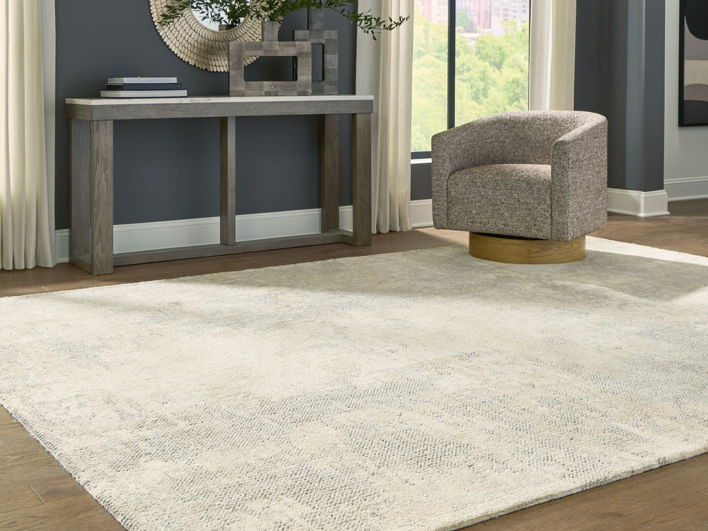 Cream area rug with gray-toned abstract design and low, even pile