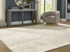 Cream area rug with gray-toned abstract design and low, even pile