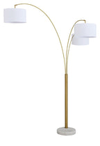 Gold metal arc floor lamp with three white fabric shades and circular base