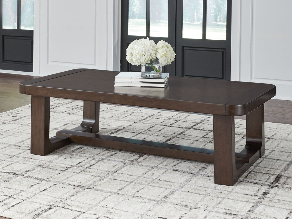 Dark brown rectangular cocktail table with solid top and sturdy block legs