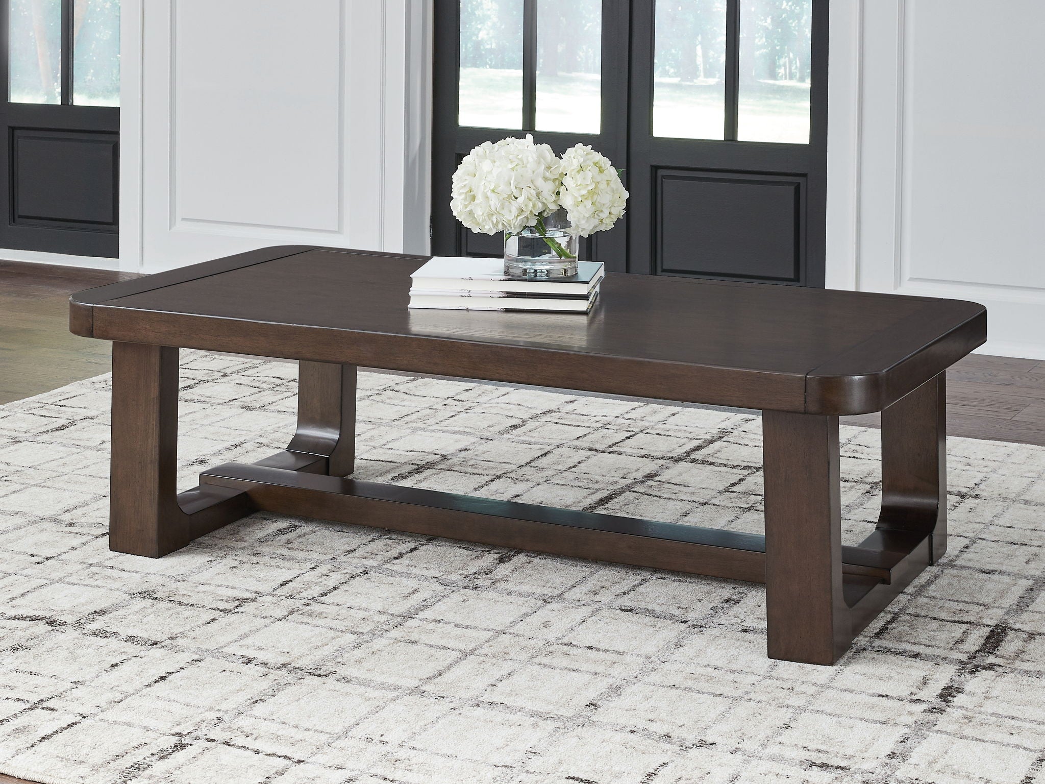 Dark brown rectangular cocktail table with solid top and sturdy block legs