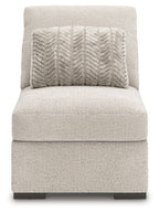 Armless accent chair in light gray fabric with patterned throw pillow and dark feet
