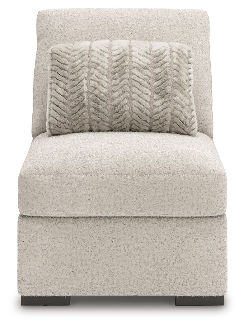 Armless accent chair in light gray fabric with patterned throw pillow and dark feet