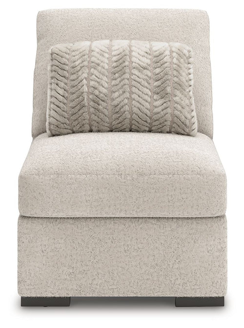Armless accent chair in light gray fabric with patterned throw pillow and dark feet