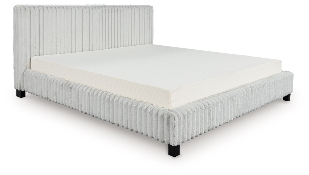 Upholstered bed with light gray ribbed headboard and sides, white mattress