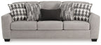 Gray flannel sofa with three seat cushions and geometric throw pillows