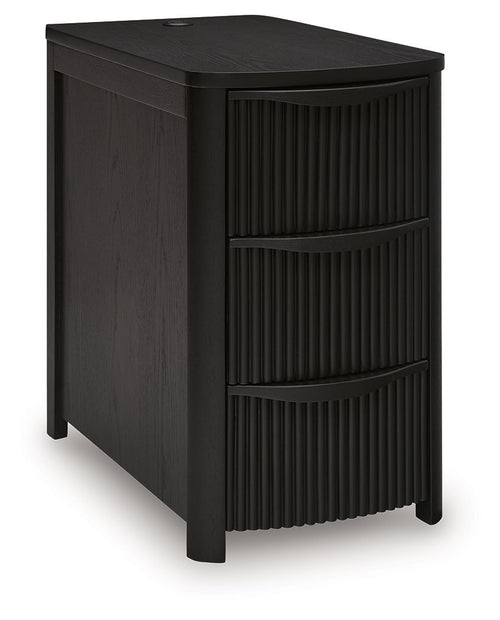 Black chair side end table with vertical slat doors and three open drawer compartments