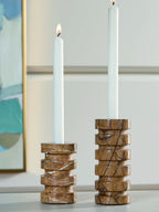 Tan marble candle holder pair with two white pillar candles in round openings