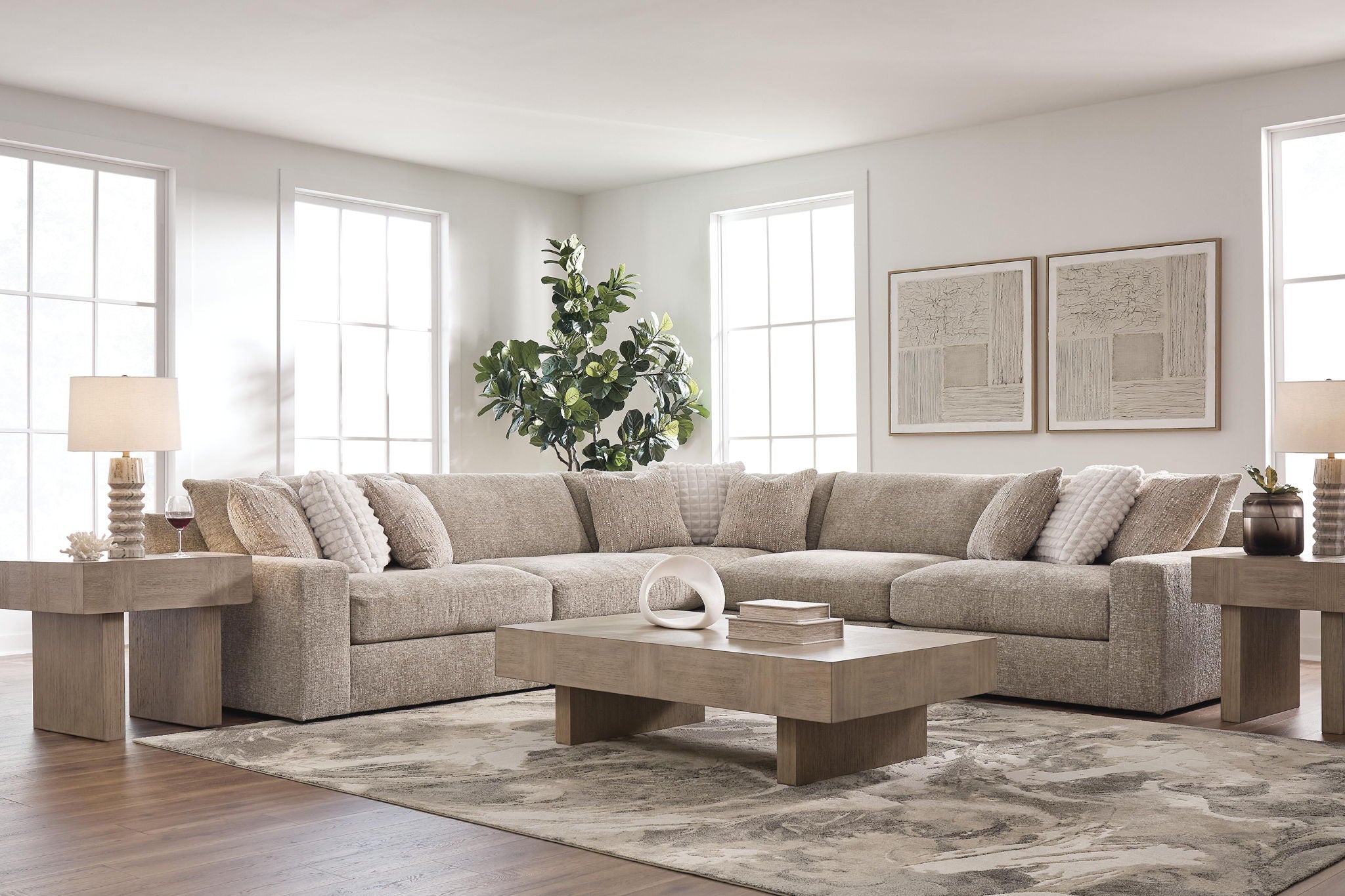 Light tan burlap-upholstered sectional sofa with chaise seating and textured pillows