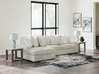 Off-white striped sectional sofa with chaise and stacked back pillows.