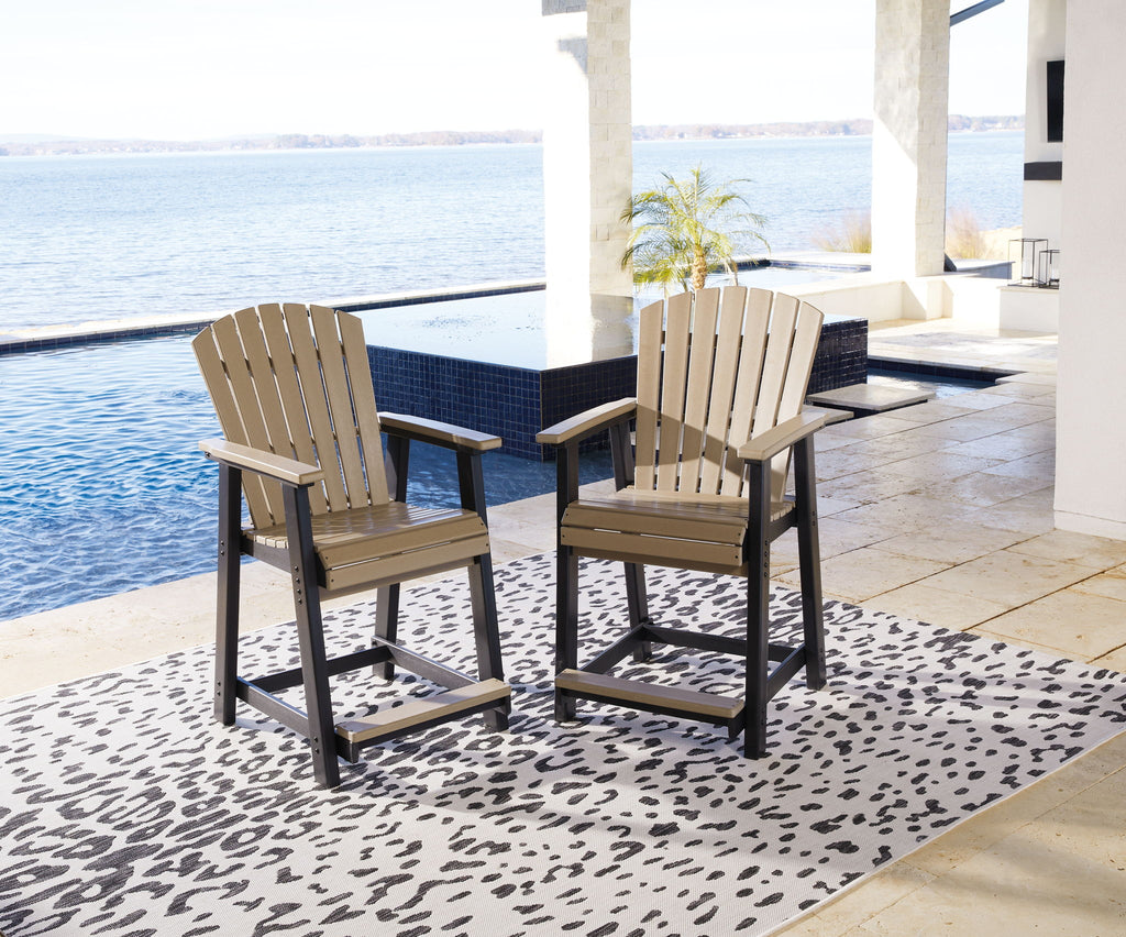 Outdoor counter dining set with two driftwood slat armchairs and dark table
