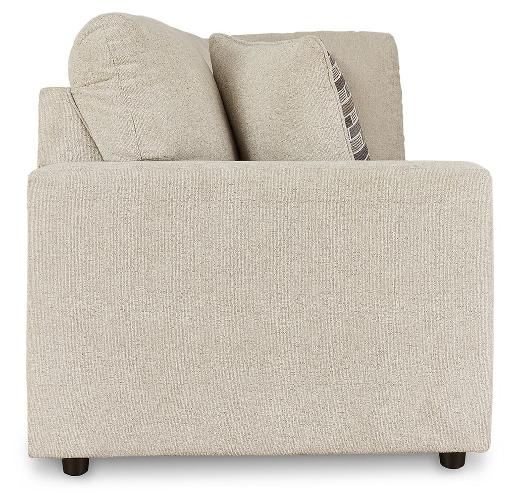 Pearl silver sofa with tall back cushions and one patterned throw pillow