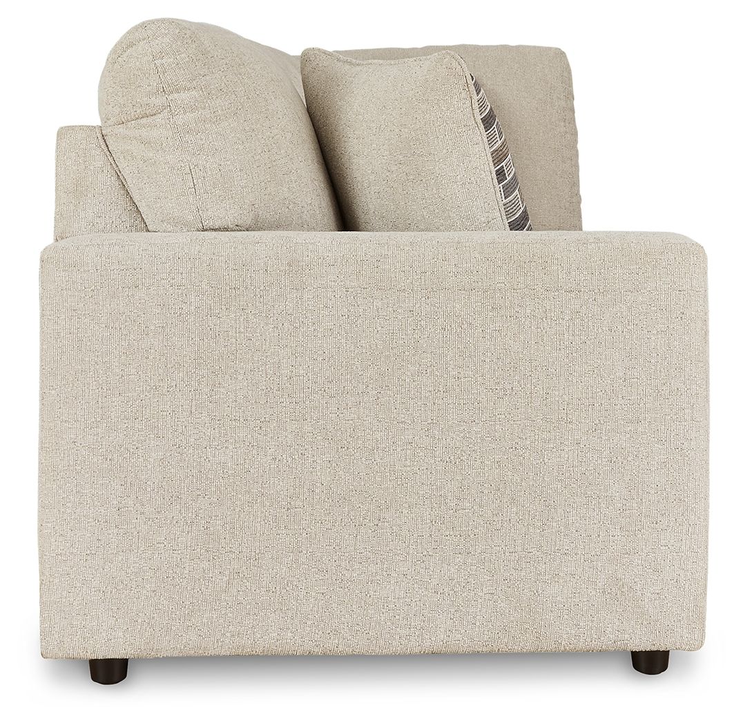 Pearl silver sofa with tall back cushions and one patterned throw pillow