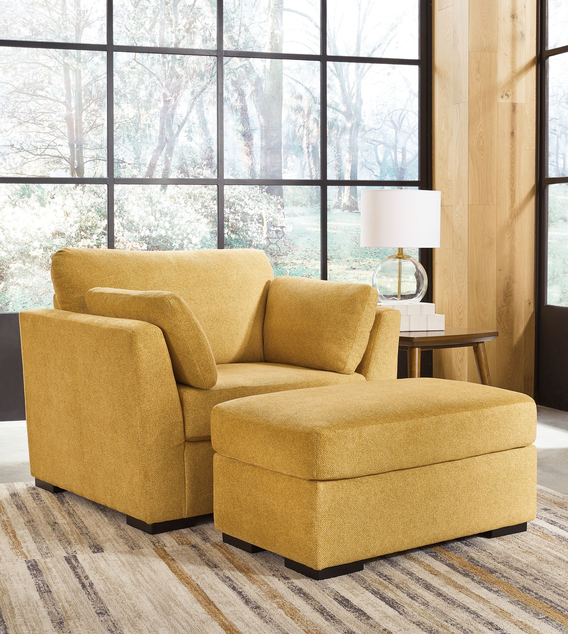 Yellow upholstered armchair with matching ottoman in front