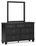Black dresser with raised mirror and three rows of drawers, silver knobs, four legs