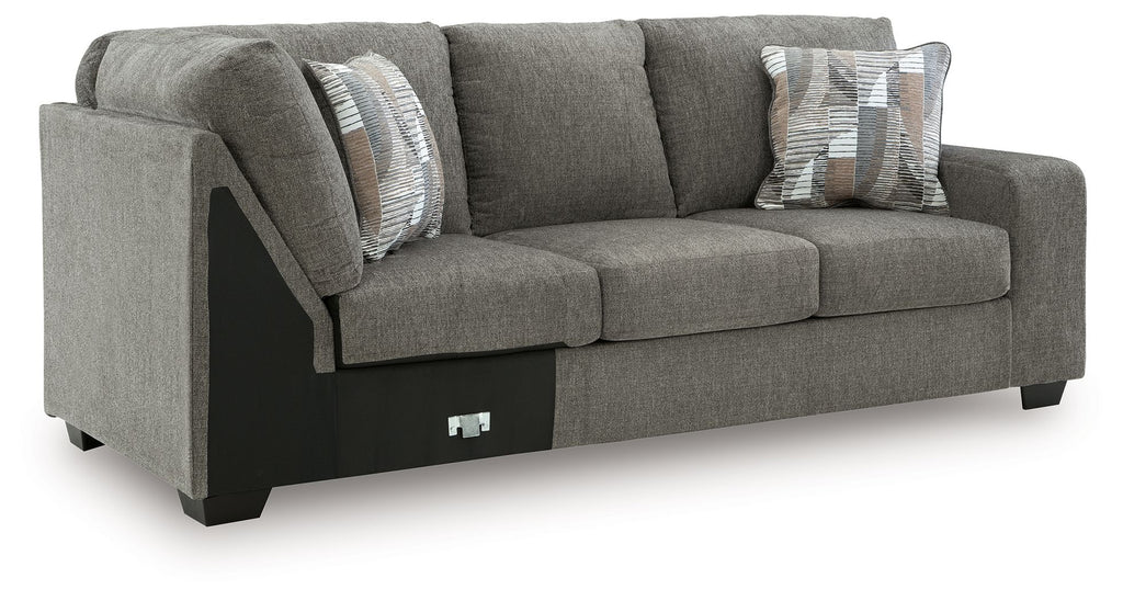 Grey RAF corner wedge sofa with two throw pillows and padded seat cushions