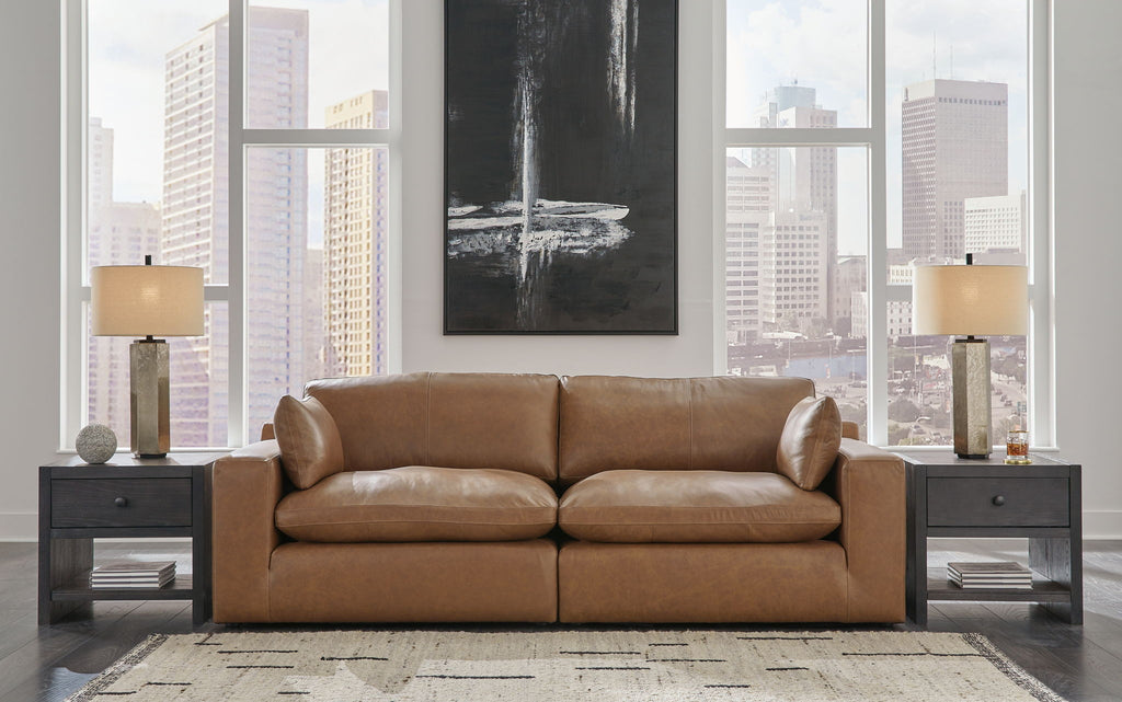 Caramel-brown sectional loveseat with chaise, rolled arms, and cushioned back