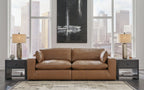 Caramel-brown sectional loveseat with chaise, rolled arms, and cushioned back