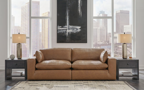 Caramel-brown sectional loveseat with chaise, rolled arms, and cushioned back