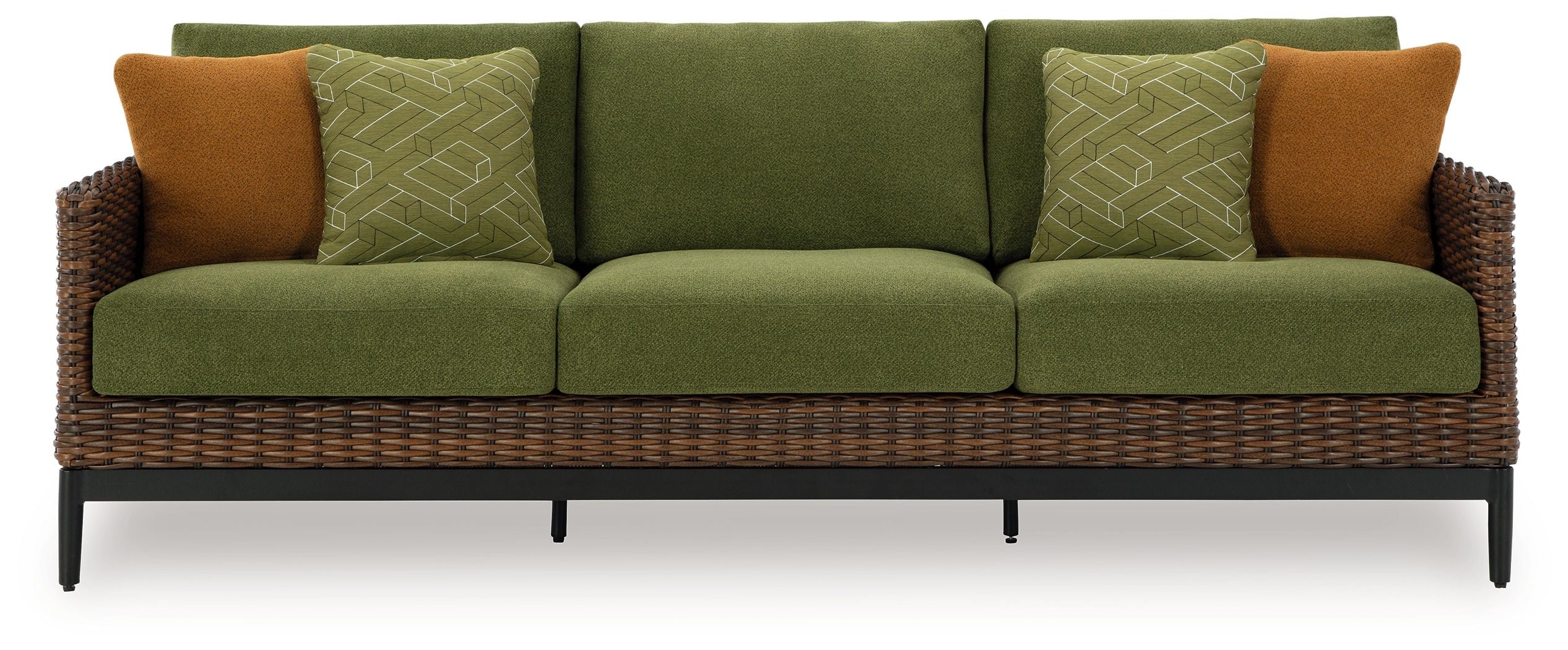 Green sofa with woven wicker frame, brown side pillows, and patterned cushions