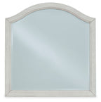 Youth bedroom mirror with arched silhouette and antique white distressed frame