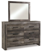 Gray dresser with six drawers and a framed wall mirror