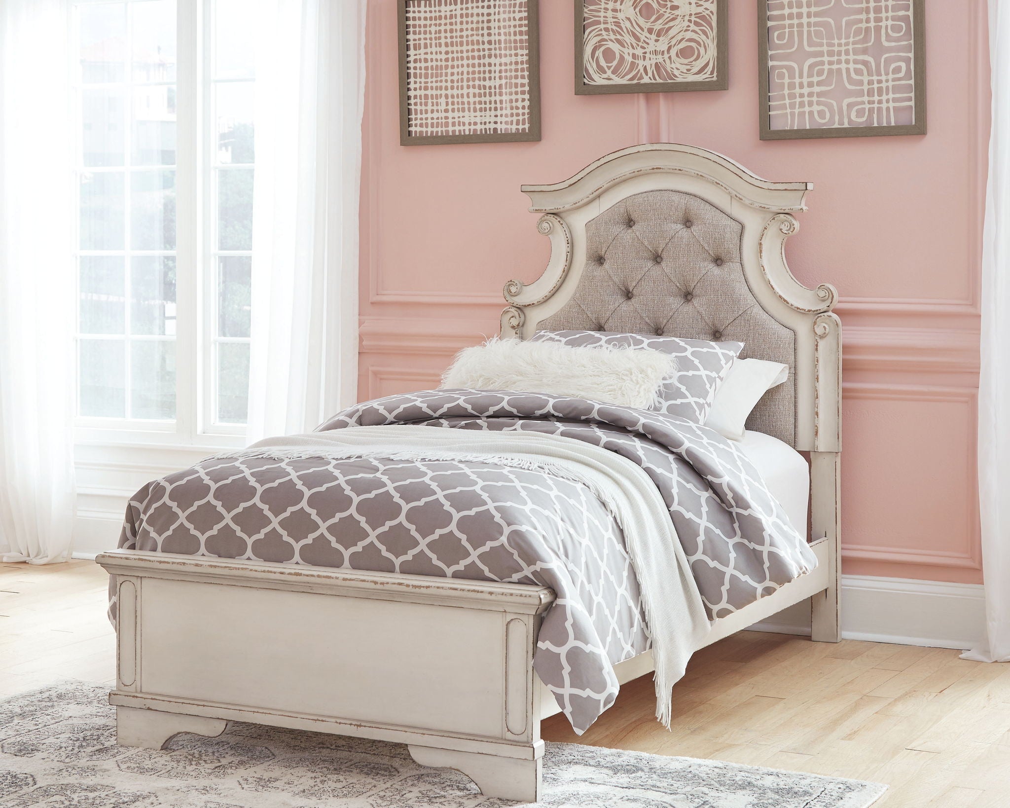 Upholstered panel bed with tufted beige headboard and white wood frame, bedding visible