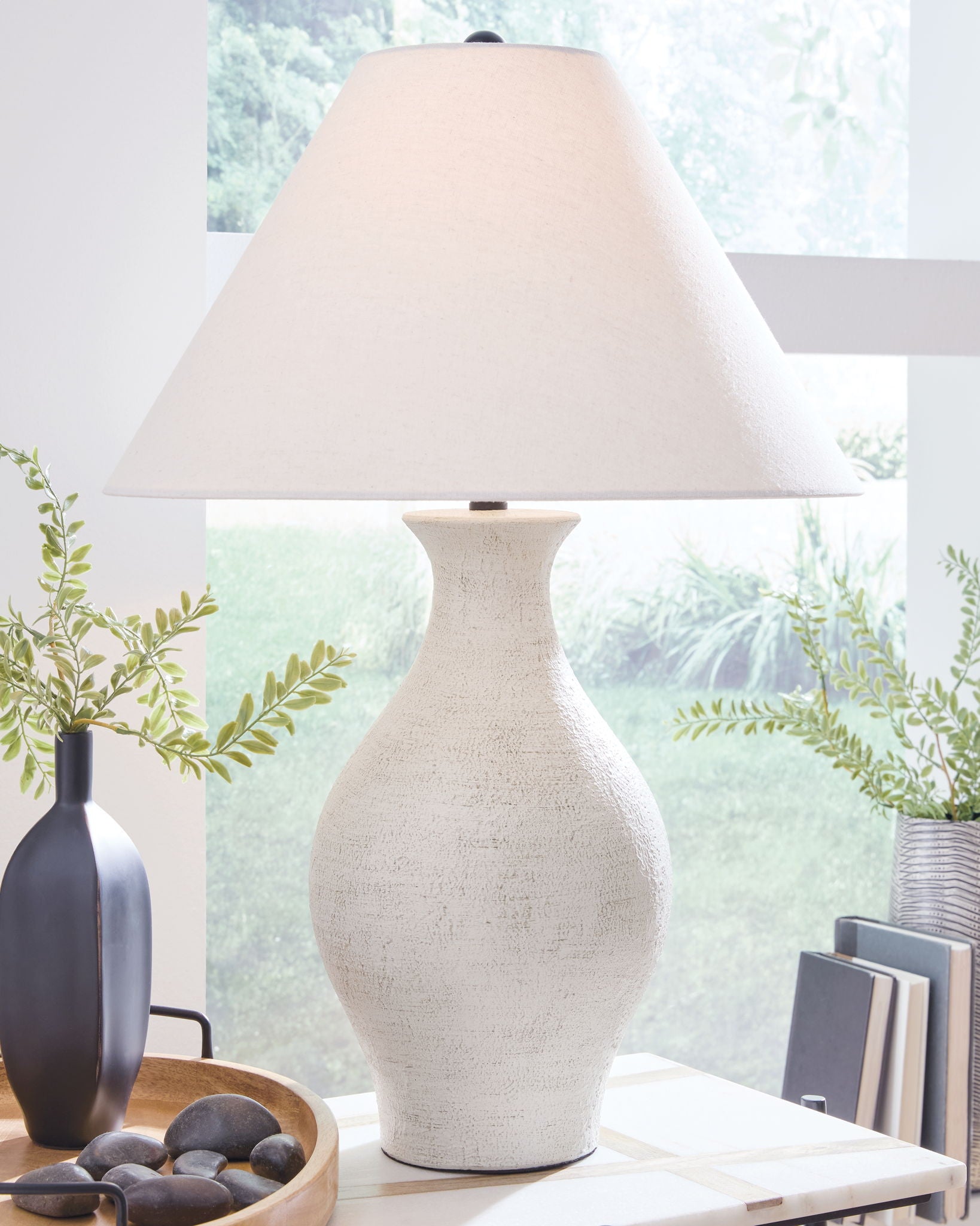 Ceramic table lamp with textured antique white base and wide off-white fabric shade