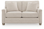Light beige upholstered loveseat with two seat cushions and three back pillows
