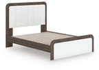 Upholstered bed with white upholstered frame, dark wood rails, and slatted base