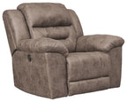 Fossil power recliner with padded arms, headrest, and taupe fabric upholstery