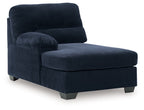 Navy corner chaise with cushioned armrest and ottoman-style seat
