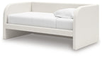 Upholstered day bed in beige fabric with white cushions; open space under the frame