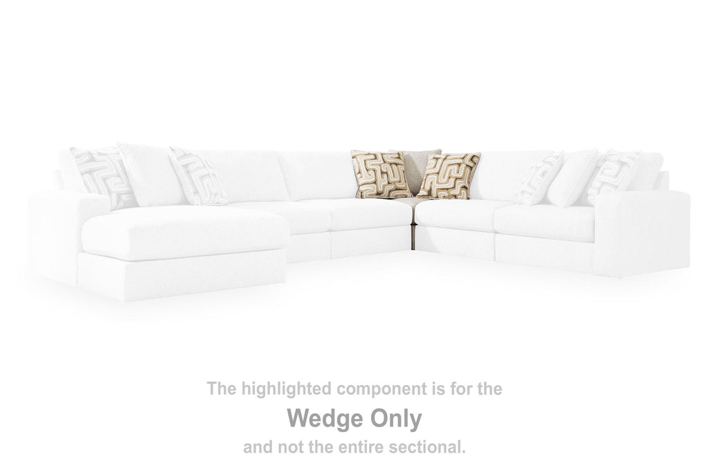 White upholstered sectional wedge with patterned accent pillows on top backrest