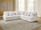 Light beige sectional sofa with chaise seating and patterned throw pillow accents