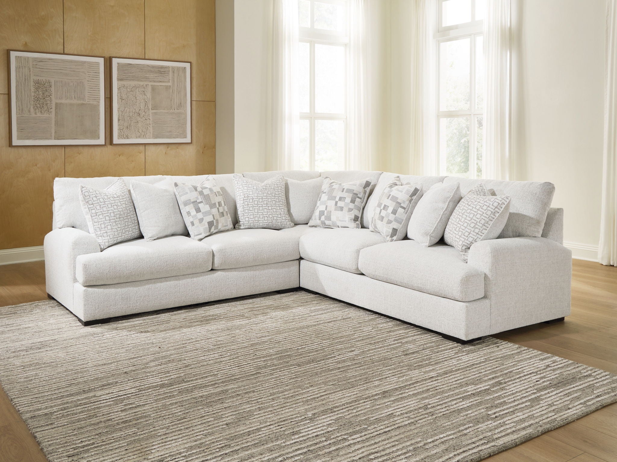 Light beige sectional sofa with chaise seating and patterned throw pillow accents