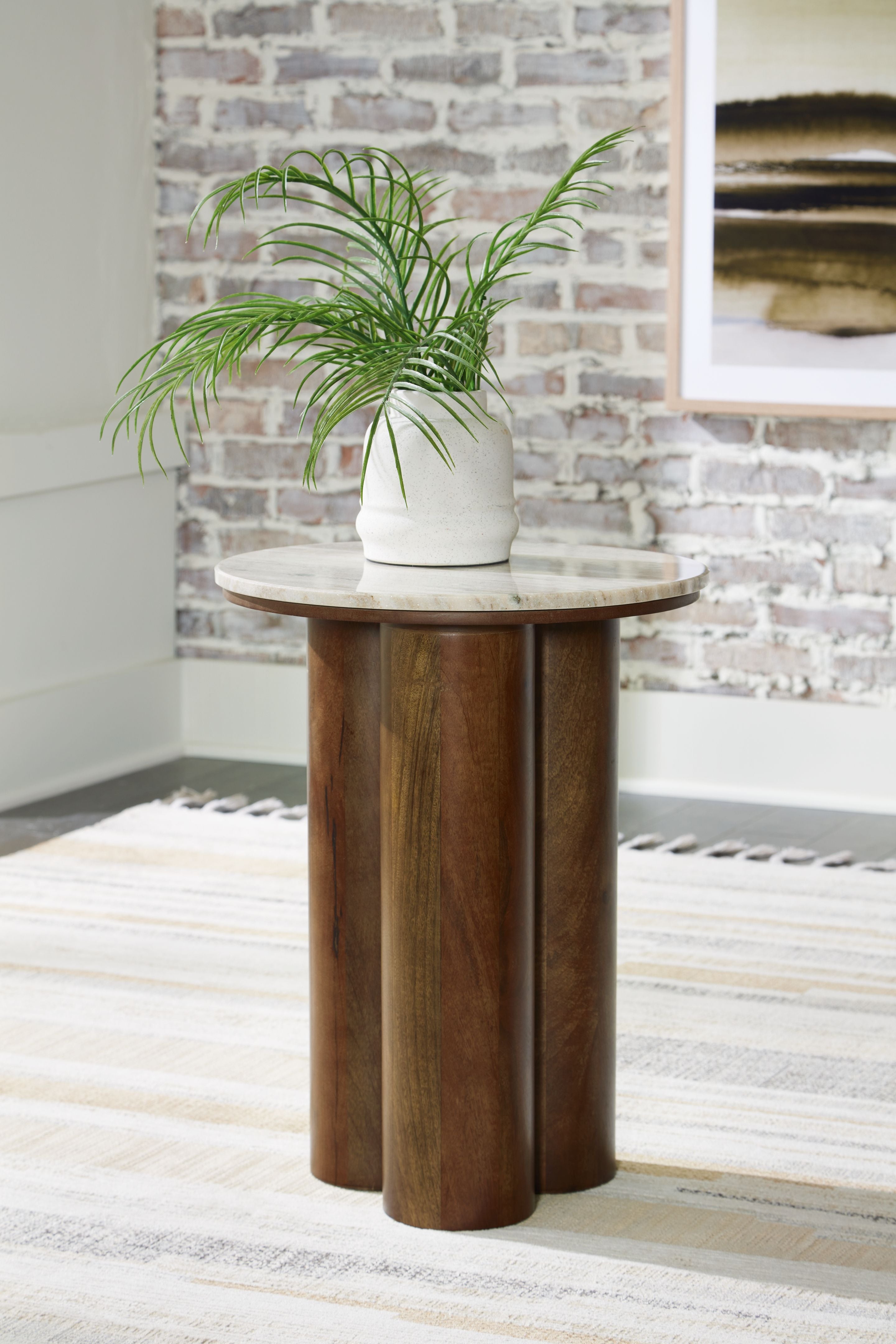 Henfield accent table with round beige stone top and brown wooden column base