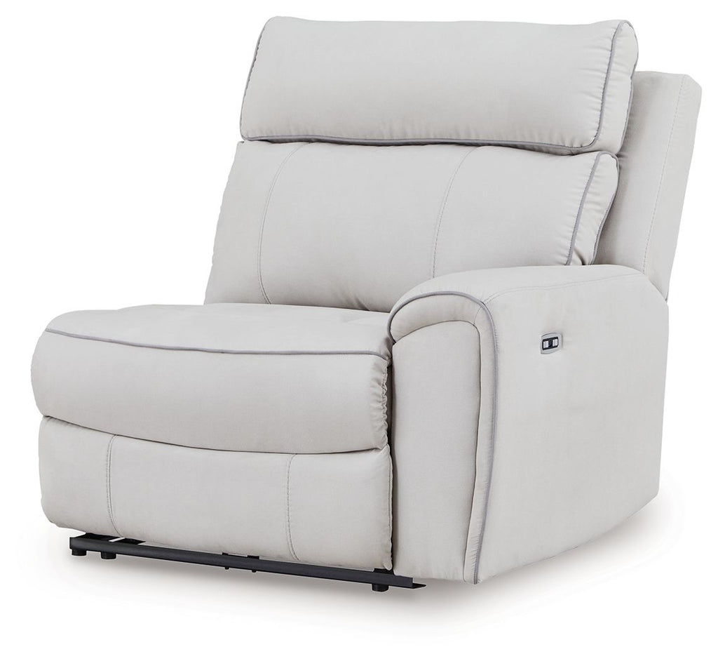 Wall power recliner chair, light gray upholstery, padded armrests and footrest.