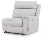 Wall power recliner chair, light gray upholstery, padded armrests and footrest.