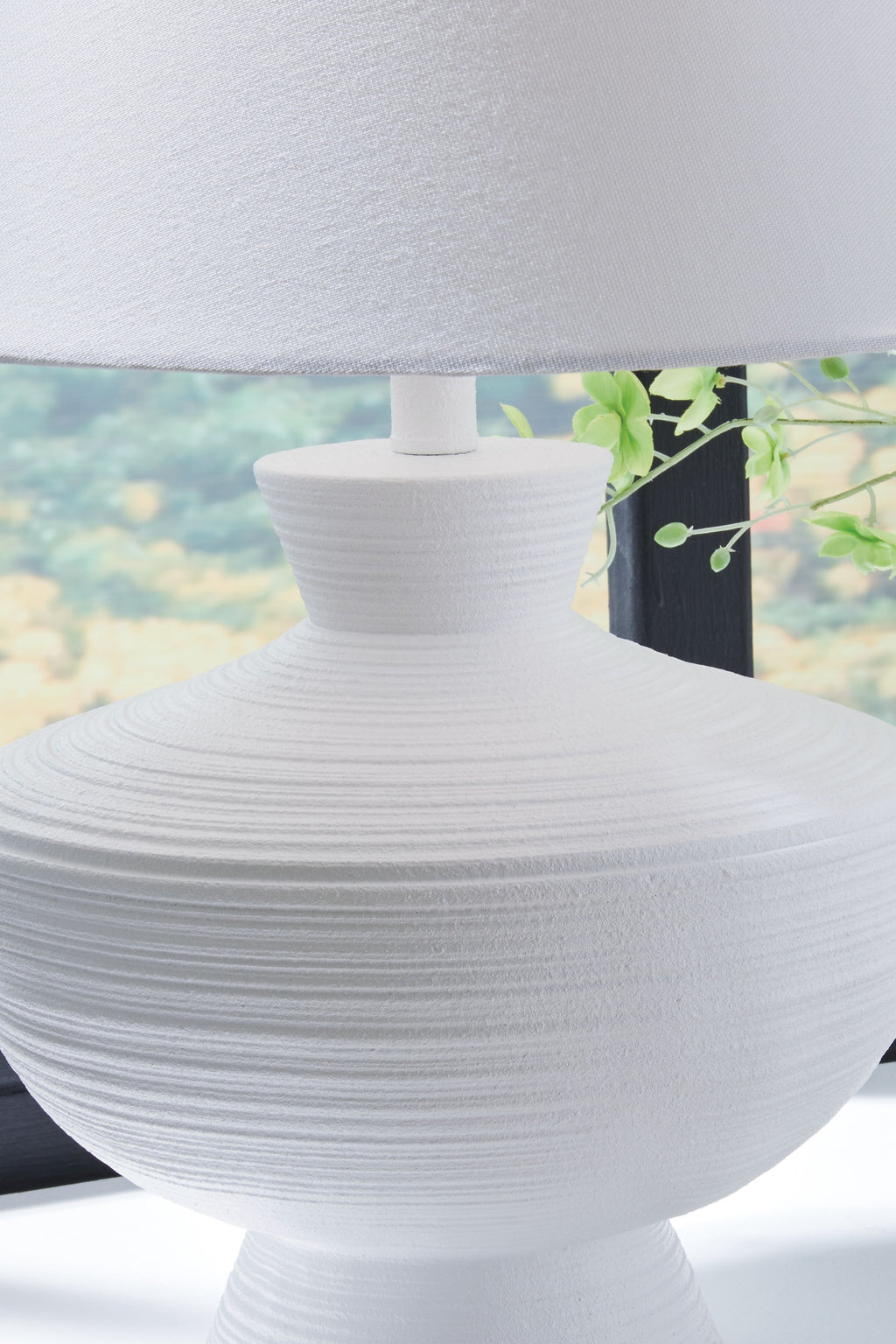 White poly table lamp with ribbed spherical body and drum shade