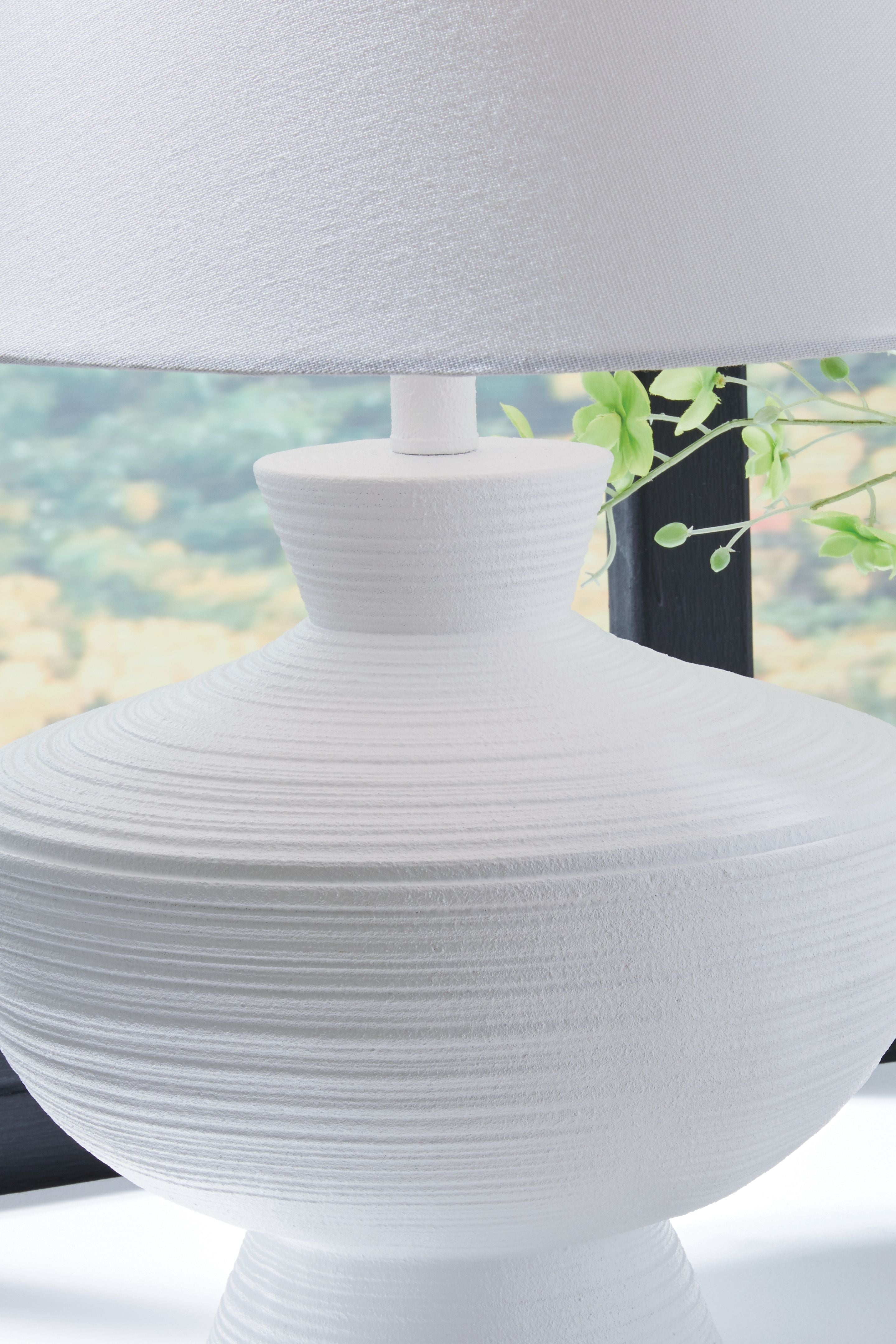 White poly table lamp with ribbed spherical body and drum shade