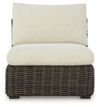 Armless wicker chair with beige seat cushion and back cushion, dark brown