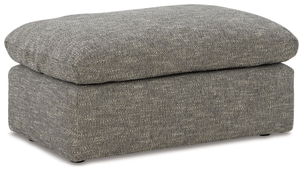 Gray upholstered ottoman with rounded lid, straight sides, and dark feet