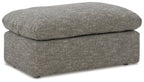 Gray upholstered ottoman with rounded lid, straight sides, and dark feet